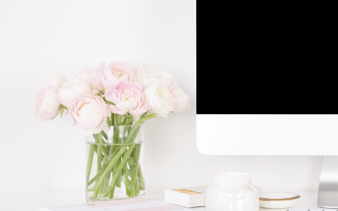blog post ideas for your business website with a black computer screen and pink flowers